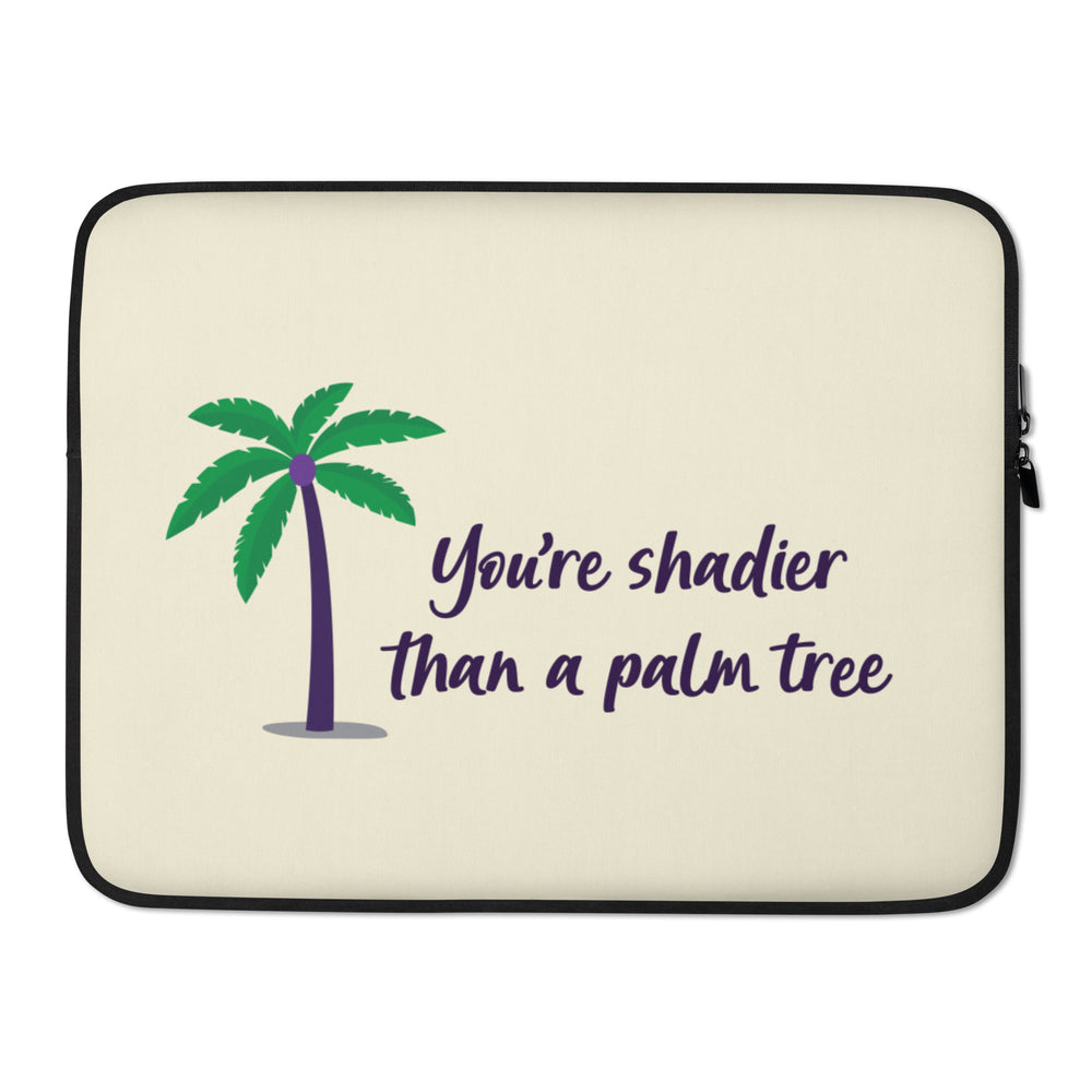 Cream laptop sleeve with a purple-trunk palm tree and “You’re shadier than a palm tree” text