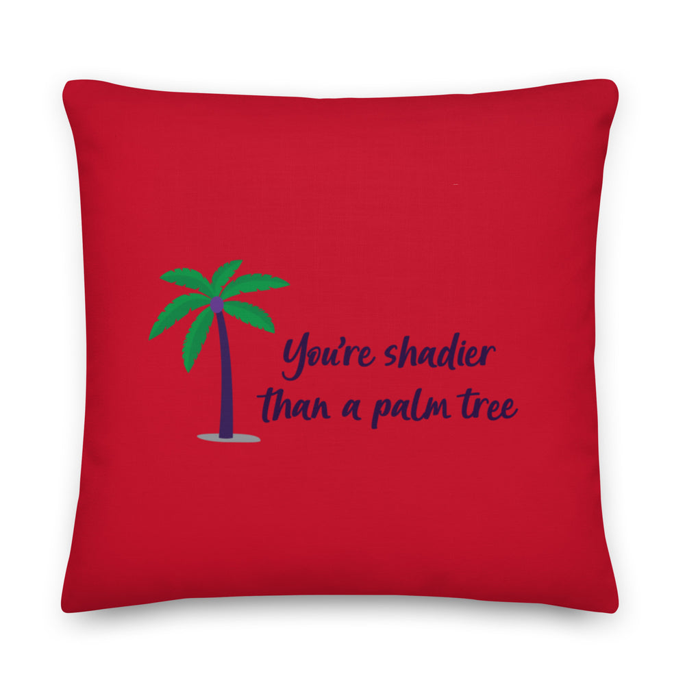 Red square pillow with a palm tree and the text “You’re shadier than a palm tree.”