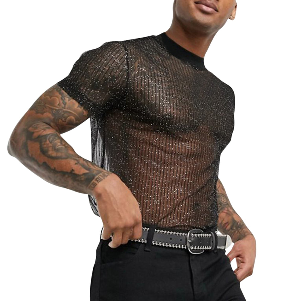 Cropped model wearing a black sheer T-shirt with glittering vertical stripes and tattoos