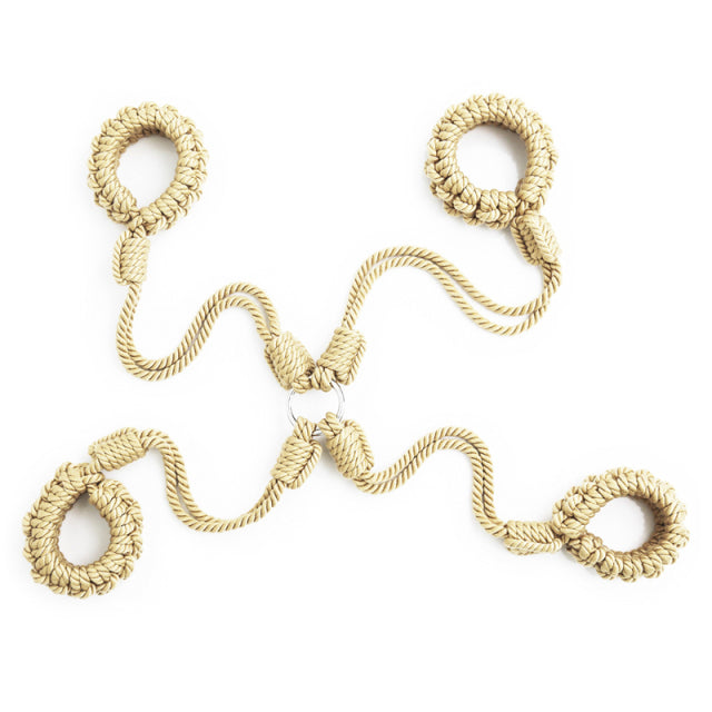 Flat lay of four beige rope handcuffs connected around metal rings