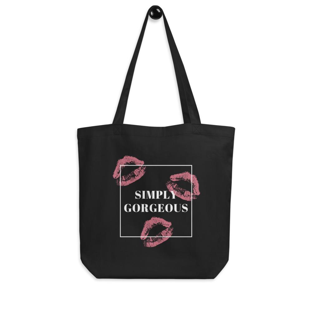 Black tote bag with pink lipstick prints and a white box reading “SIMPLY GORGEOUS”