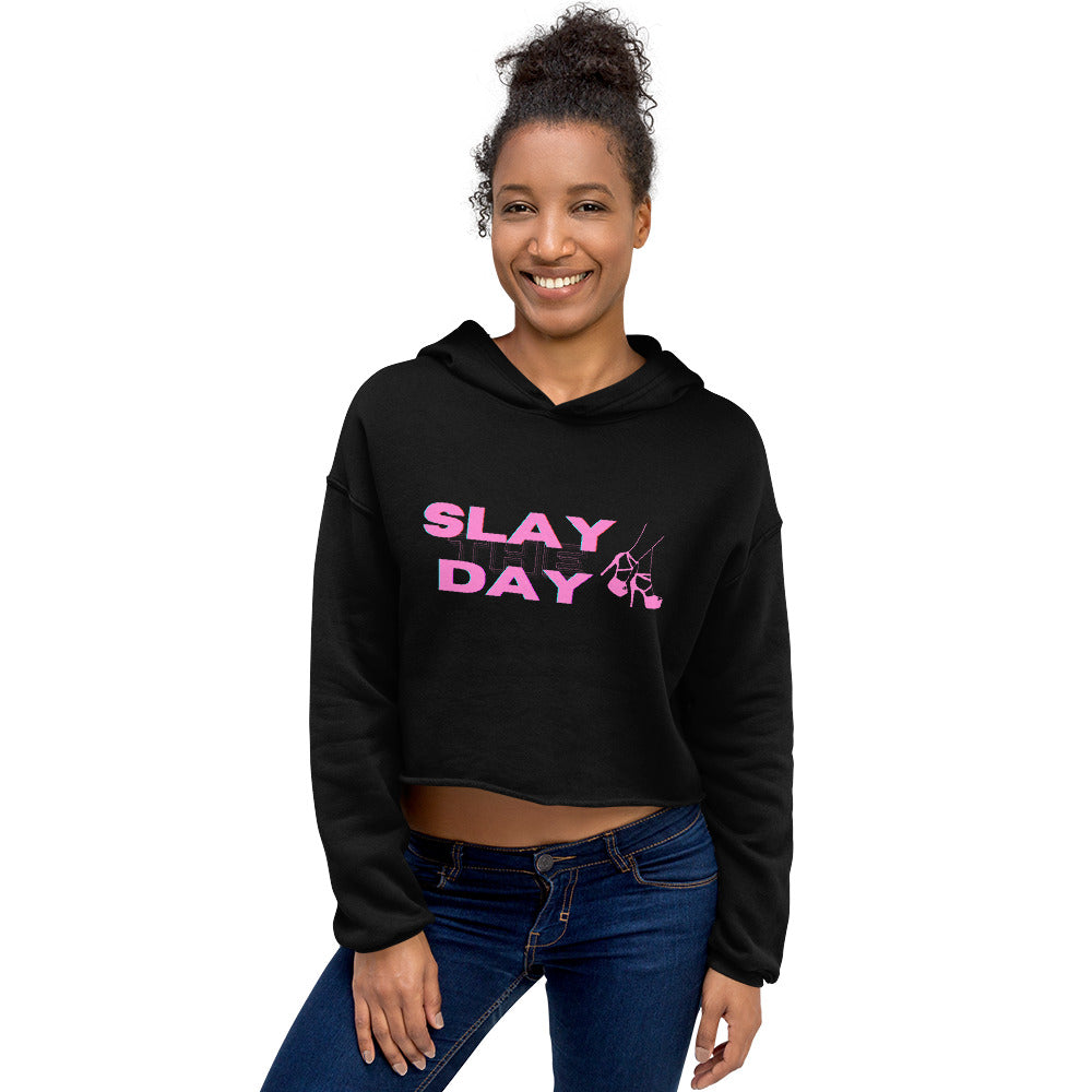Model wearing a black cropped hoodie with pink “SLAY DAY” lettering and a high-heel graphic