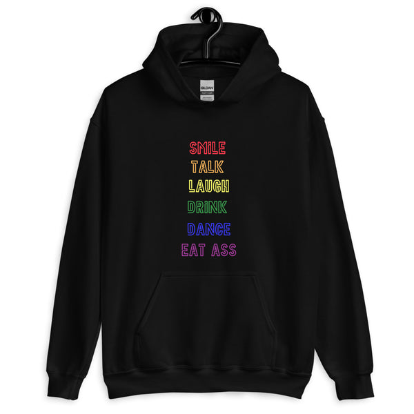 Front-view black hoodie with rainbow text reading “SMILE TALK LAUGH DRINK DANCE EAT ASS”