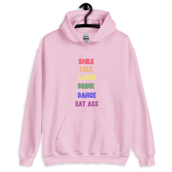 Front view of a pink pullover hoodie reading “SMILE TALK LAUGH DRINK DANCE EAT ASS.”