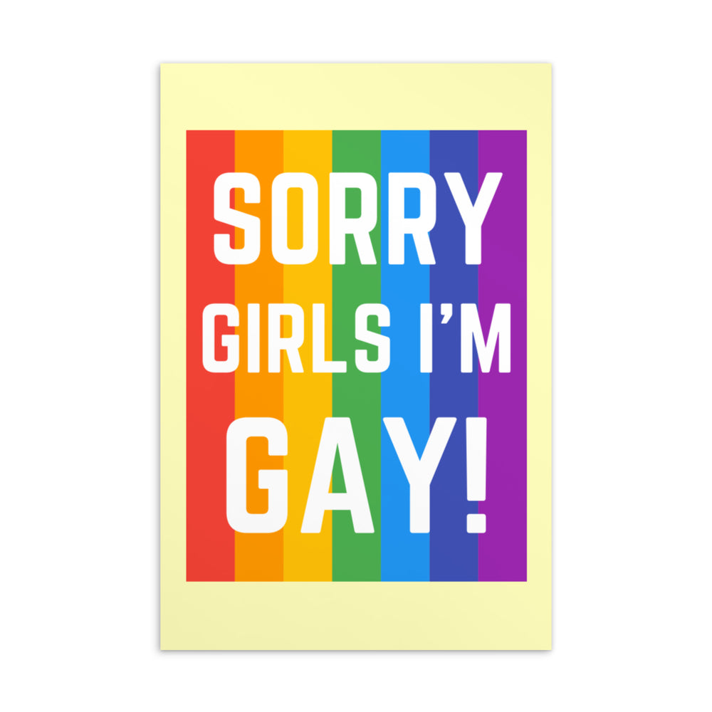 Front of a postcard reading “SORRY GIRLS I’M GAY!” over rainbow stripes