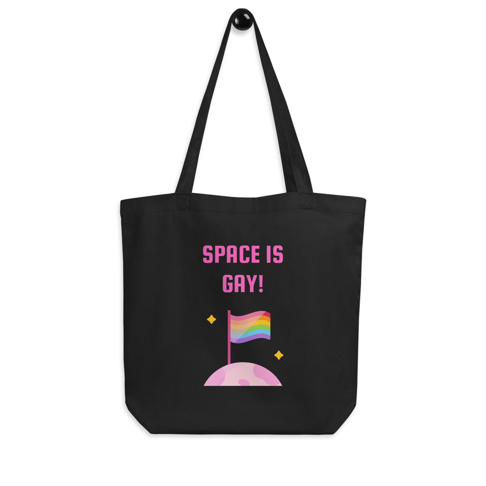 Front view of a black tote bag reading “SPACE IS GAY!” with a rainbow flag and pink moon
