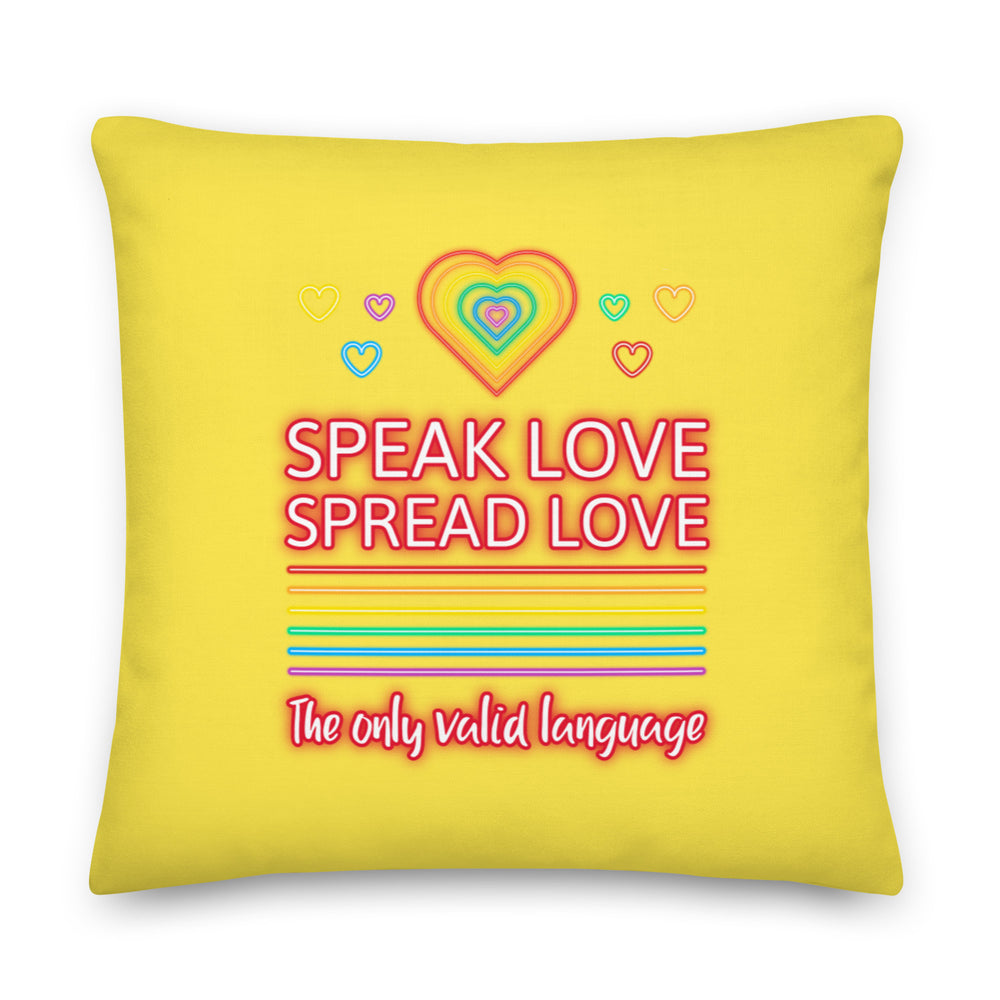 Yellow square pillow reading “SPEAK LOVE SPREAD LOVE” with rainbow hearts and stripes