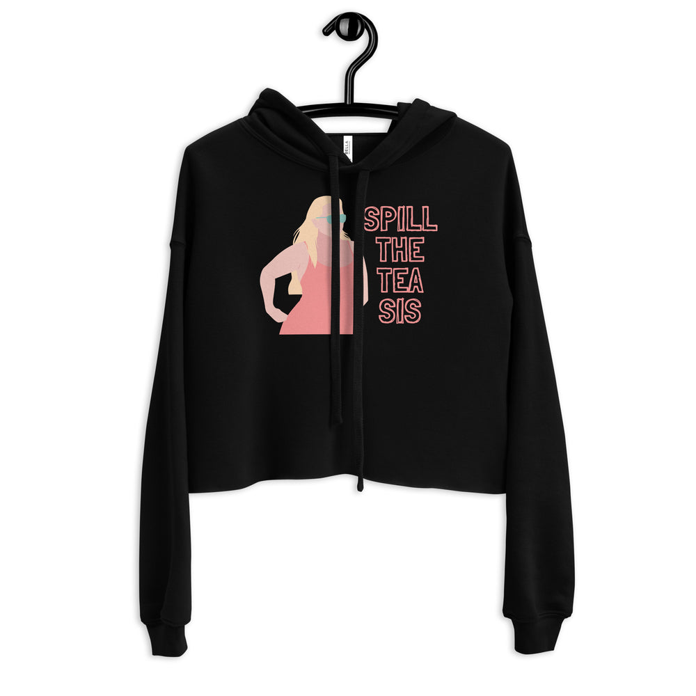 Front view of a black cropped hoodie on a hanger with a woman graphic and “SPILL THE TEA SIS” text