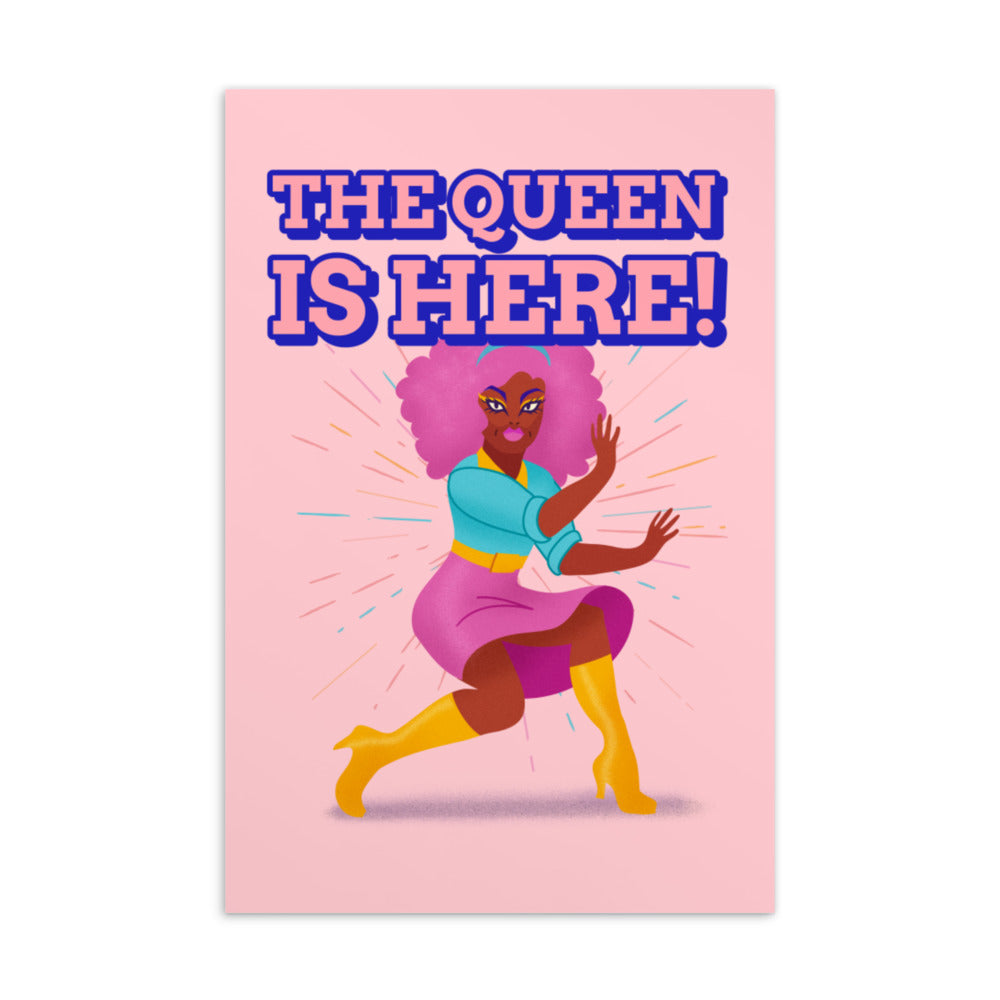 Pink postcard reading “THE QUEEN IS HERE!” with an illustrated woman in colorful clothing and yellow boots