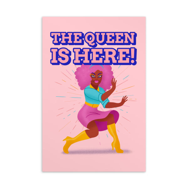 Pink postcard reading “THE QUEEN IS HERE!” with an illustrated woman in colorful clothing and yellow boots