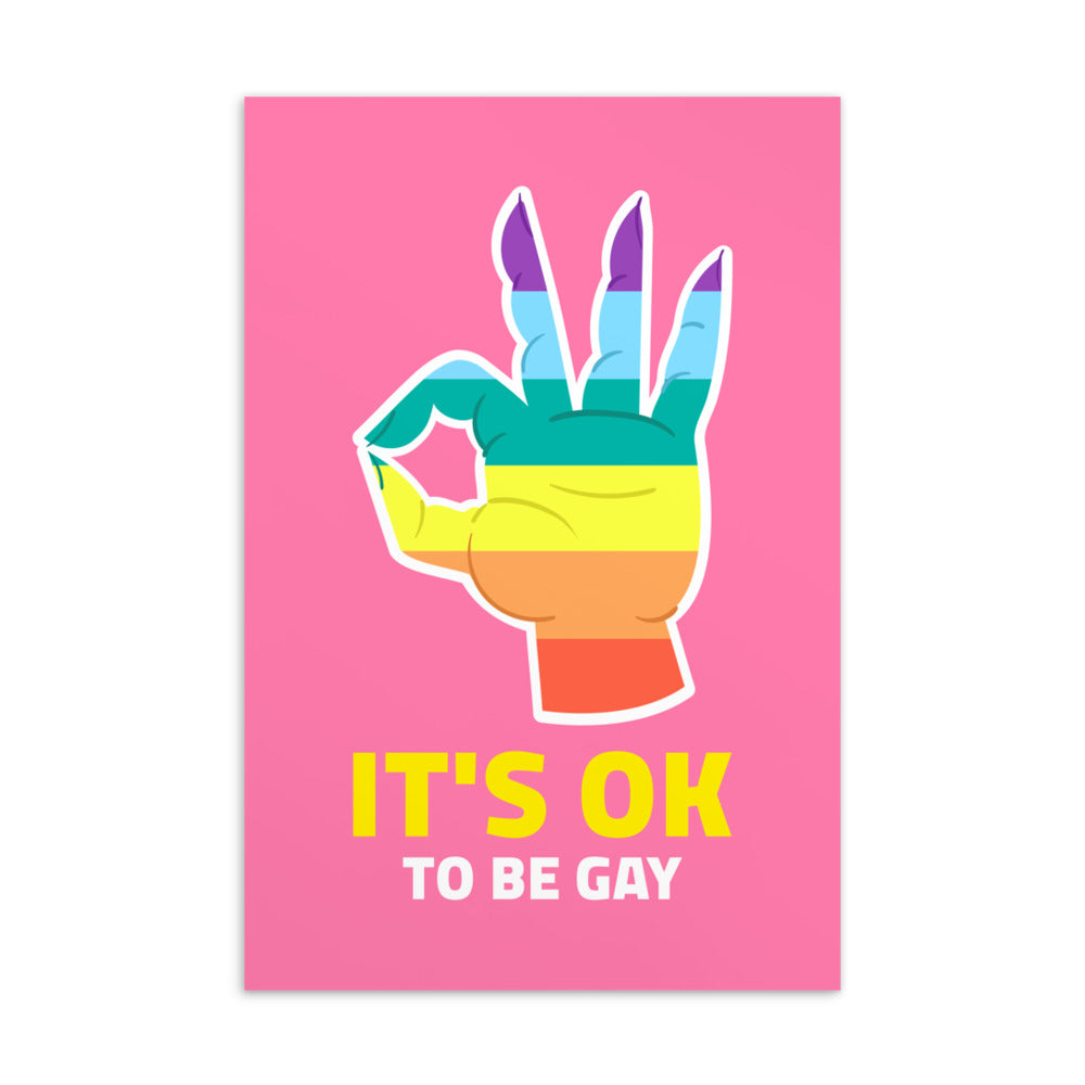 Pink postcard reading “IT’S OK TO BE GAY” beneath a rainbow-colored hand illustration
