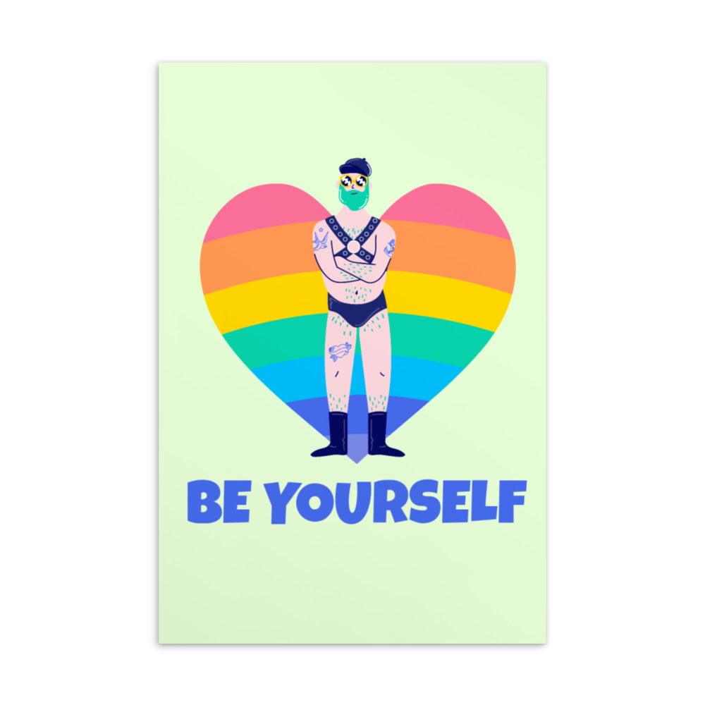 Front of a “BE YOURSELF” postcard showing a tattooed person in harness and briefs before a rainbow heart