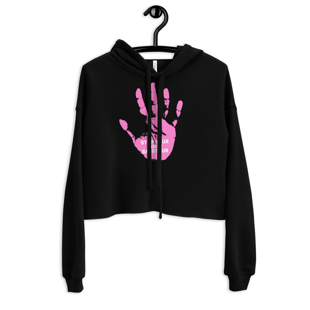 Front view of a black cropped hoodie with a pink handprint and “STOP YOUR INNER SABOTEUR” text