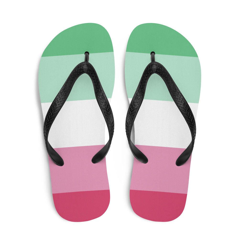 Pair of abrosexual pride flip-flops with black straps and green, white, and pink bands