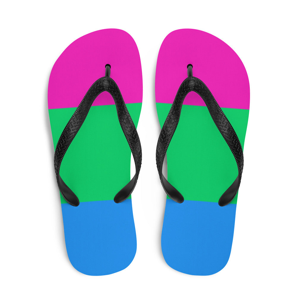 Pair of flip-flops with pink, green, and blue striped soles and black straps