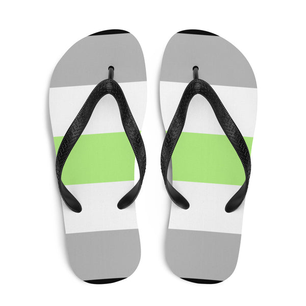 Pair of agender pride flip-flops shown from above with black straps and gray, white, and lime-green bands