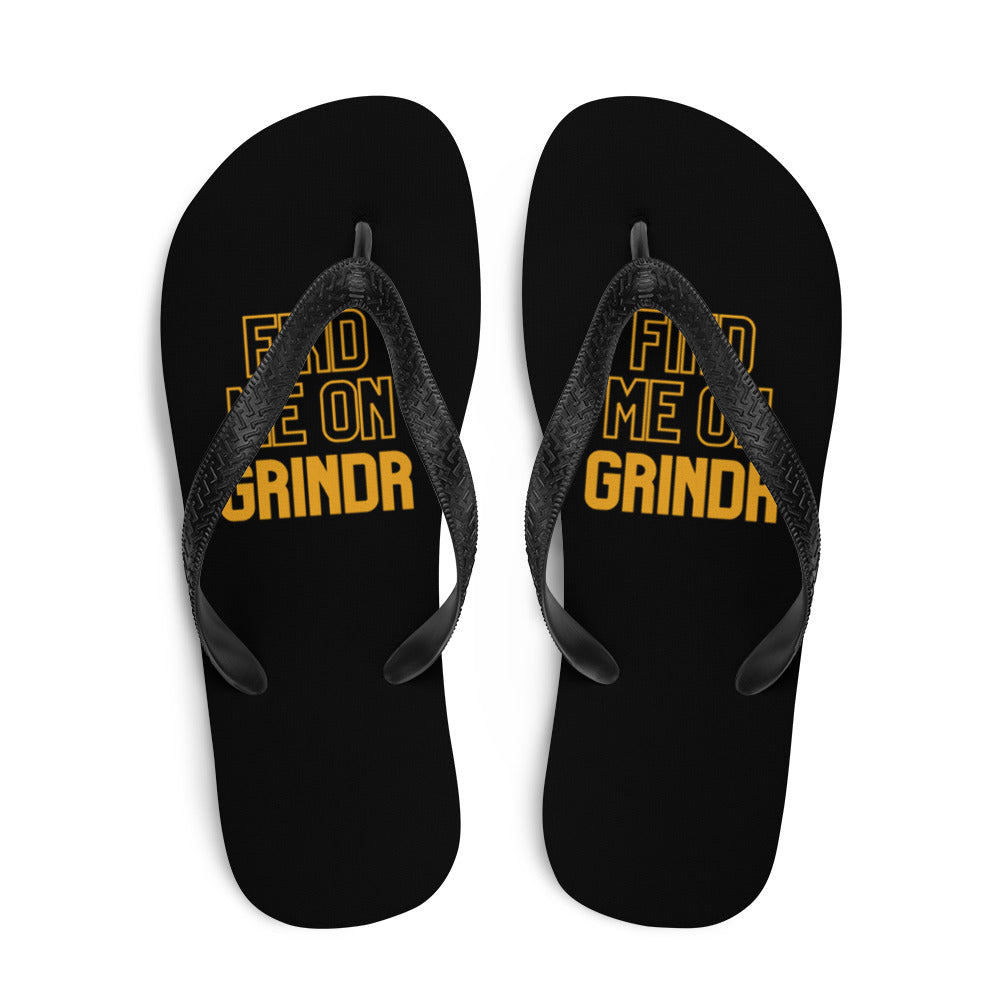Pair of black flip-flops with yellow “FIND ME ON GRINDR” text