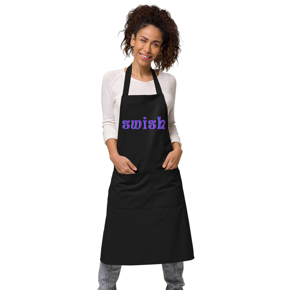 Front view of a model wearing a black apron with purple-and-blue “swish” lettering and front pockets