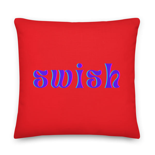 Front-facing red square pillow with purple and cyan lettering reading “swish”