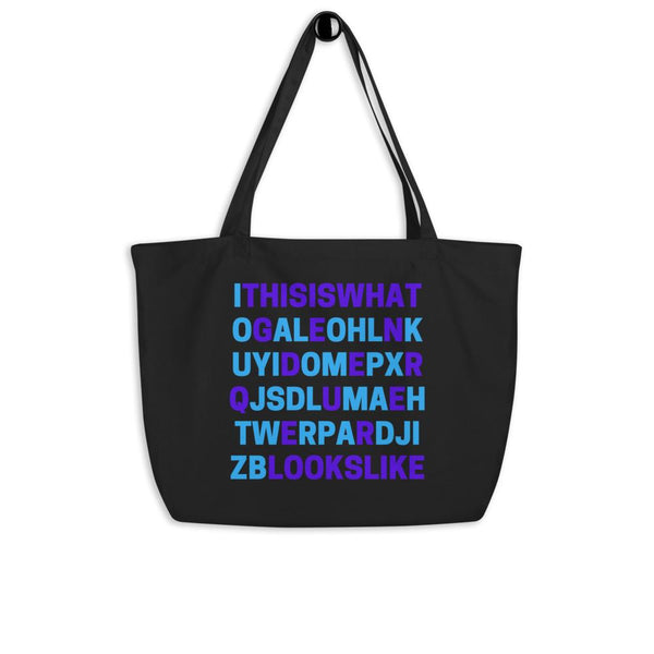 Black tote bag with colorful block lettering reading “THIS IS WHAT GENDERQUEER LOOKS LIKE”