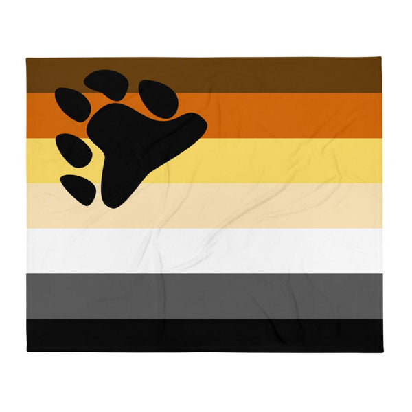 Gay bear pride throw blanket laid flat, with a black paw print over brown, orange, yellow, white, gray, and black stripes