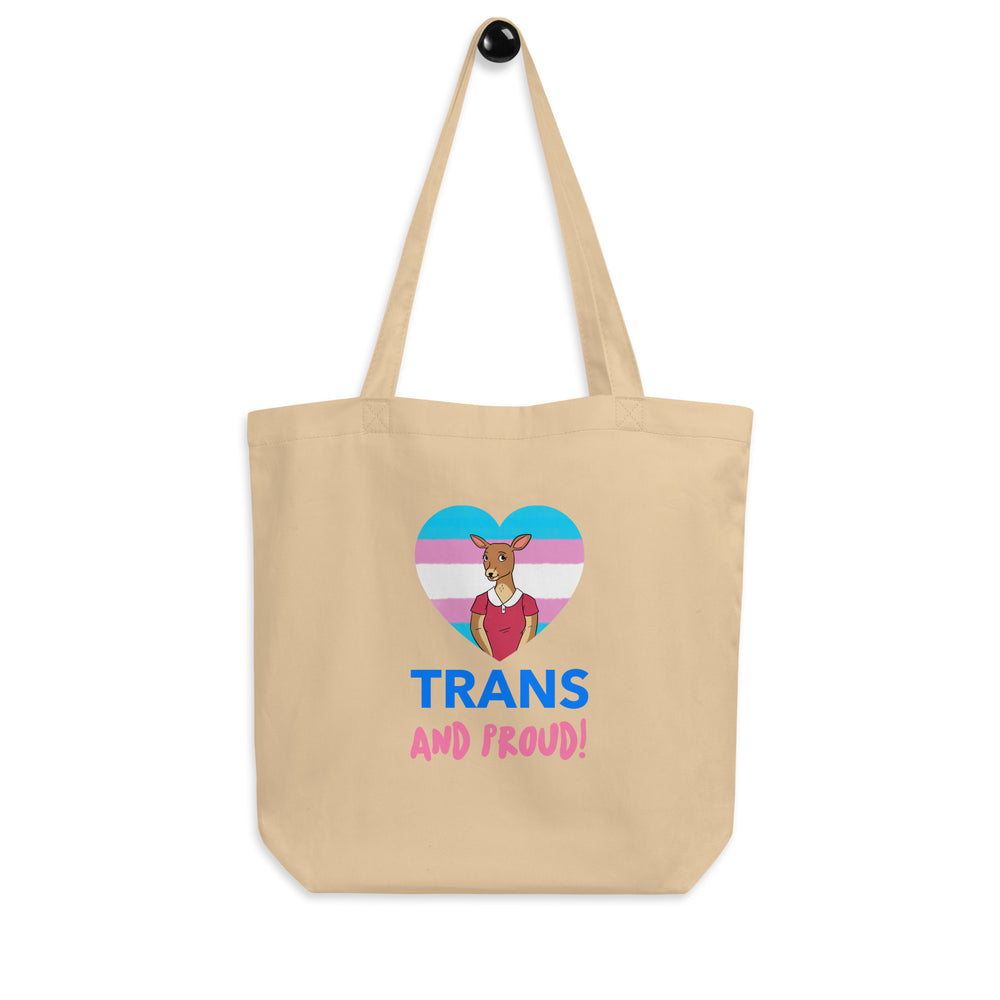 Oyster canvas tote bag with a trans pride heart graphic and “TRANS AND PROUD!” text