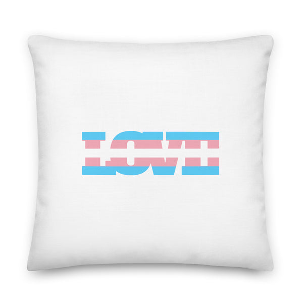 Transgender Love Pillow on a mat, “LOVE” in blue, pink, and white stripes evoking the trans flag; cozy queer living room vibes.