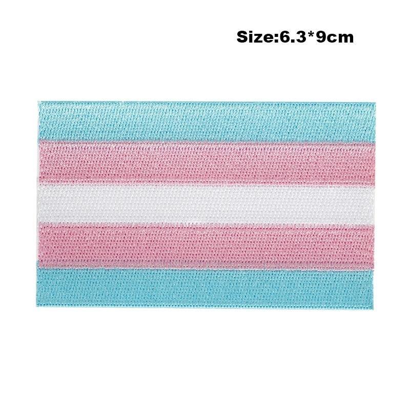 Close-up of a transgender pride embroidered patch with blue, pink, and white stripes