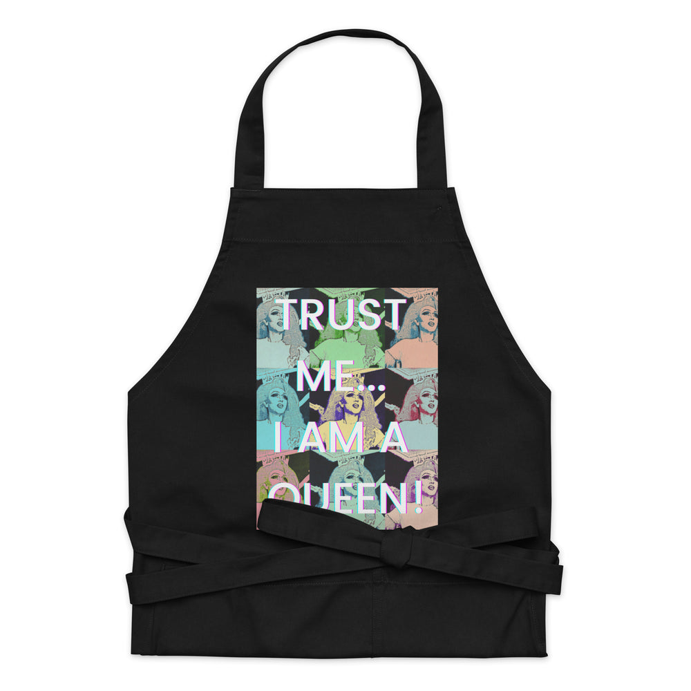 Front view of a black apron with a colorful queen collage and “TRUST ME... I AM A QUEEN!”