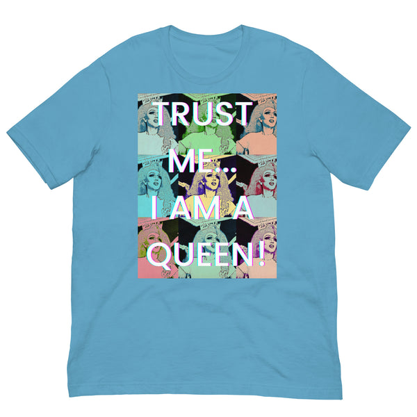 Flat-lay ocean-blue T-shirt with pop-art portraits and “TRUST ME… I AM A QUEEN!” text
