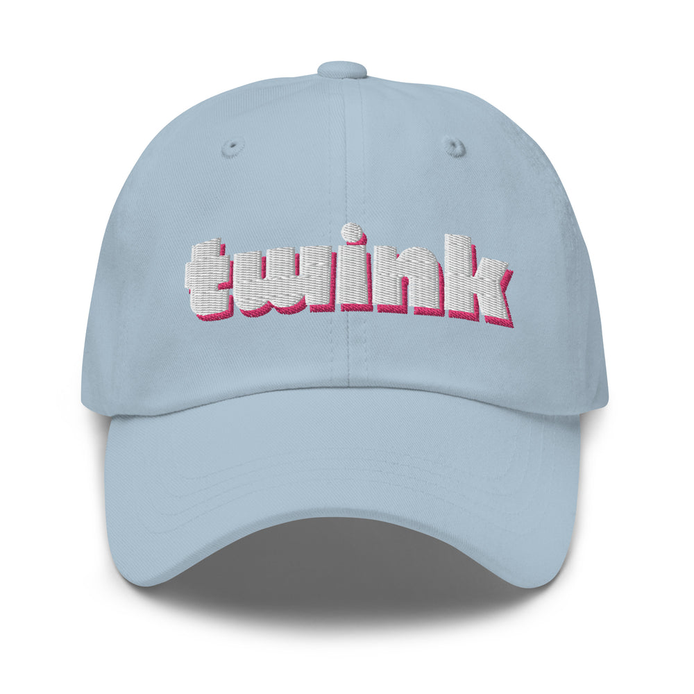 twinks on twinks: Light blue embroidered Twink Cap, styled on a person in a black mesh top, silver chains, rings; neon-lit