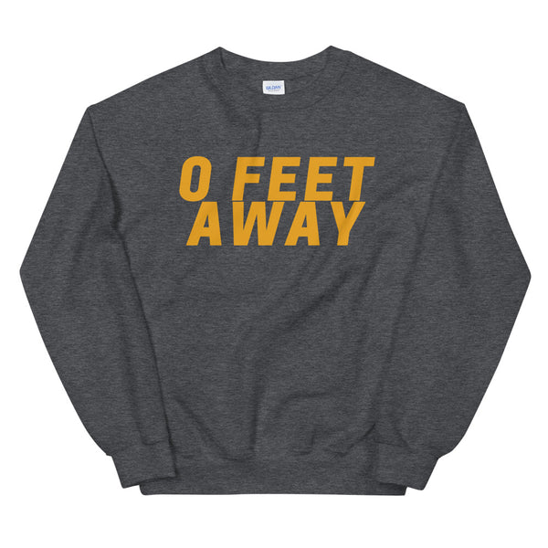 Front view of a dark gray sweatshirt reading “0 FEET AWAY” in large yellow letters
