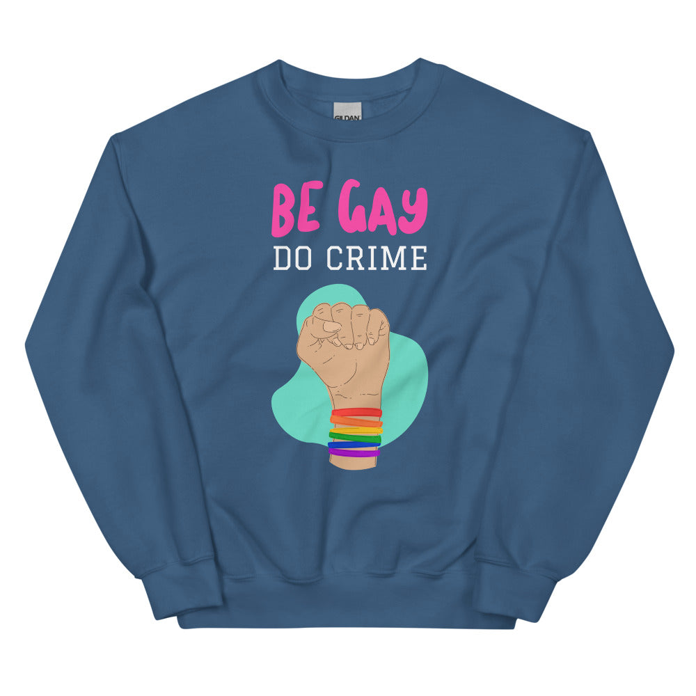 Blue crewneck sweatshirt reading “BE GAY DO CRIME” with a raised fist and rainbow wristbands