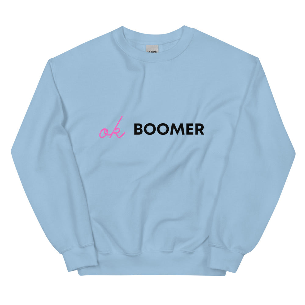 Front view of a light blue sweatshirt reading “ok BOOMER” in pink and black