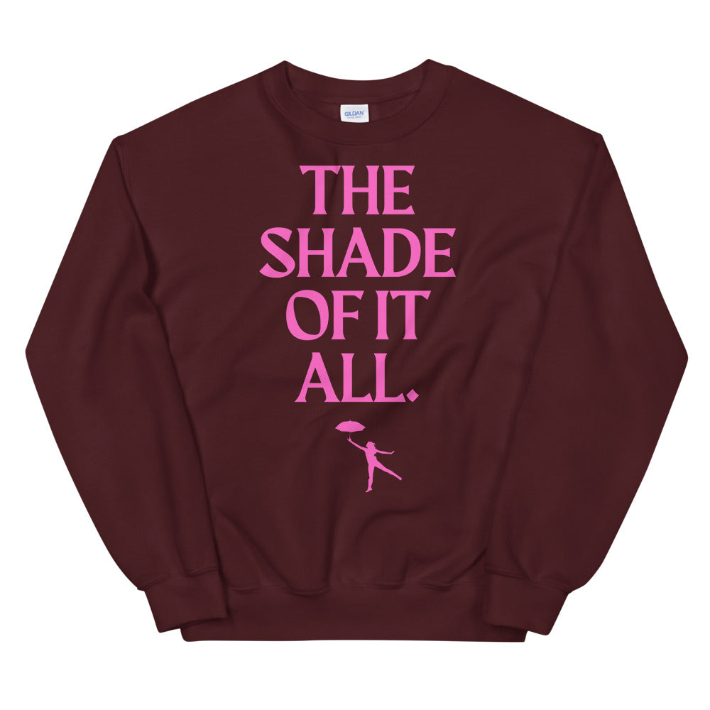 Burgundy unisex sweatshirt with pink “THE SHADE OF IT ALL.” text and umbrella figure