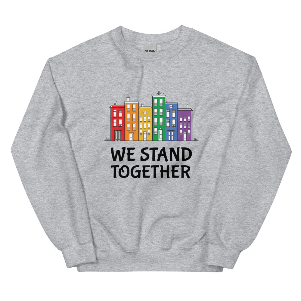 Front view of a heather gray sweatshirt with colorful buildings and “WE STAND TOGETHER” text