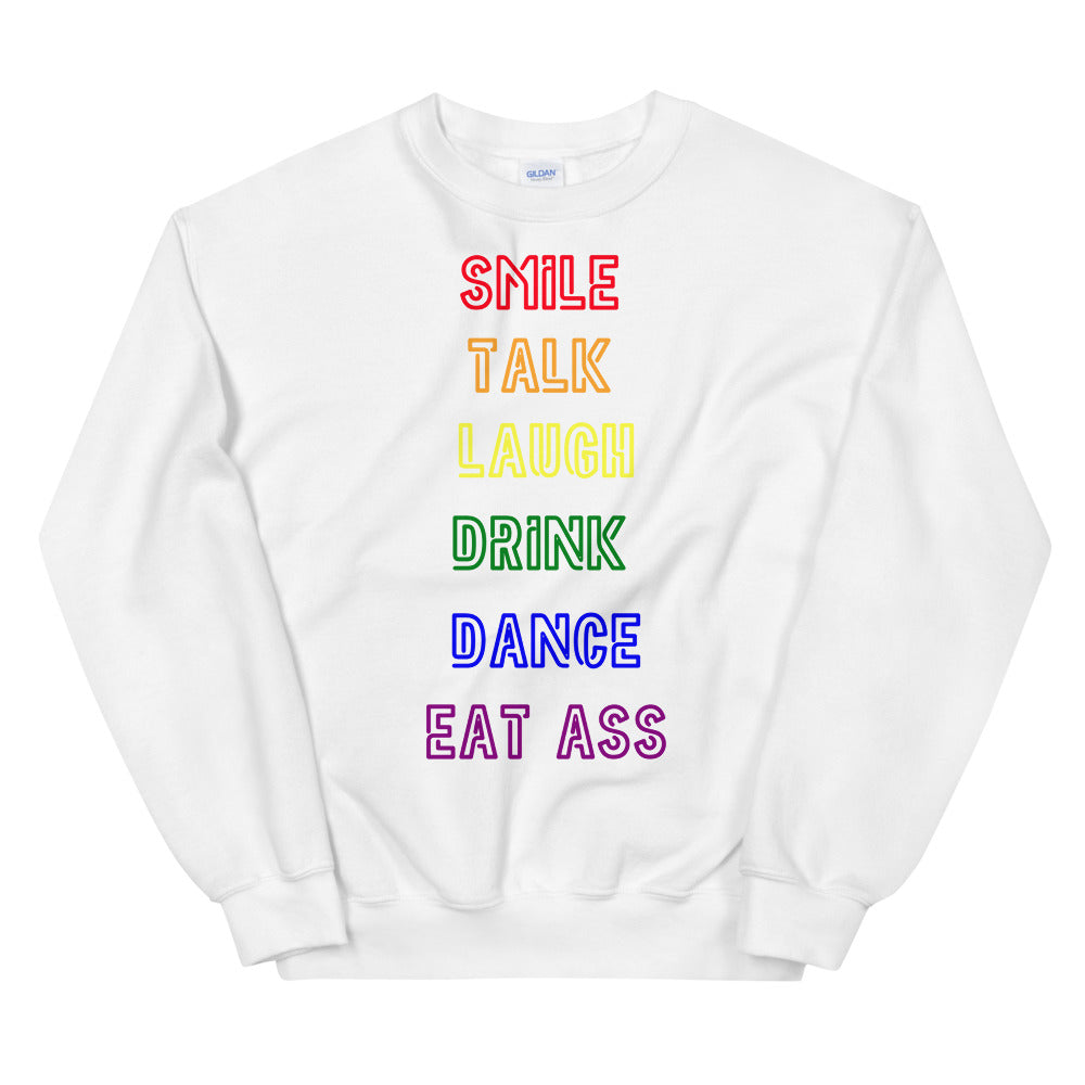 White sweatshirt with rainbow text reading “SMILE TALK LAUGH DRINK DANCE EAT ASS”