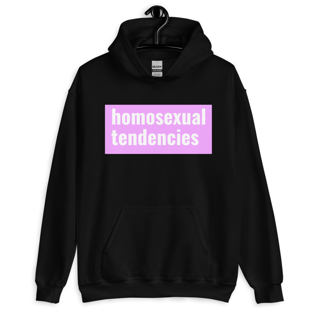 Front view of a black hoodie reading “homosexual tendencies” in white on pink