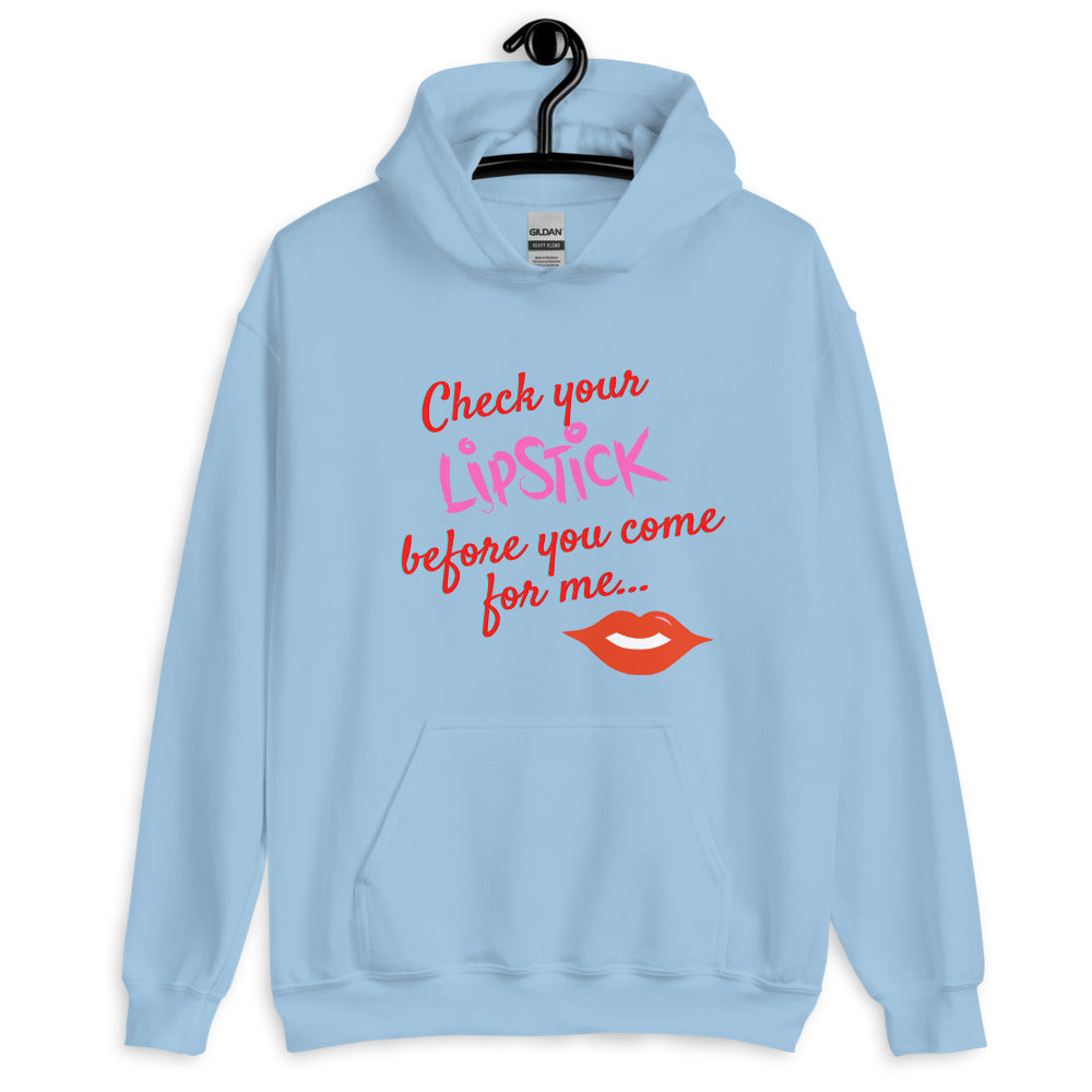 Light blue pullover hoodie on a hanger reading “Check your lipstick before you come for me…”