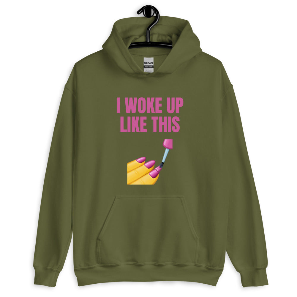 Olive green hoodie on a hanger with pink “I WOKE UP LIKE THIS” text and manicure graphic