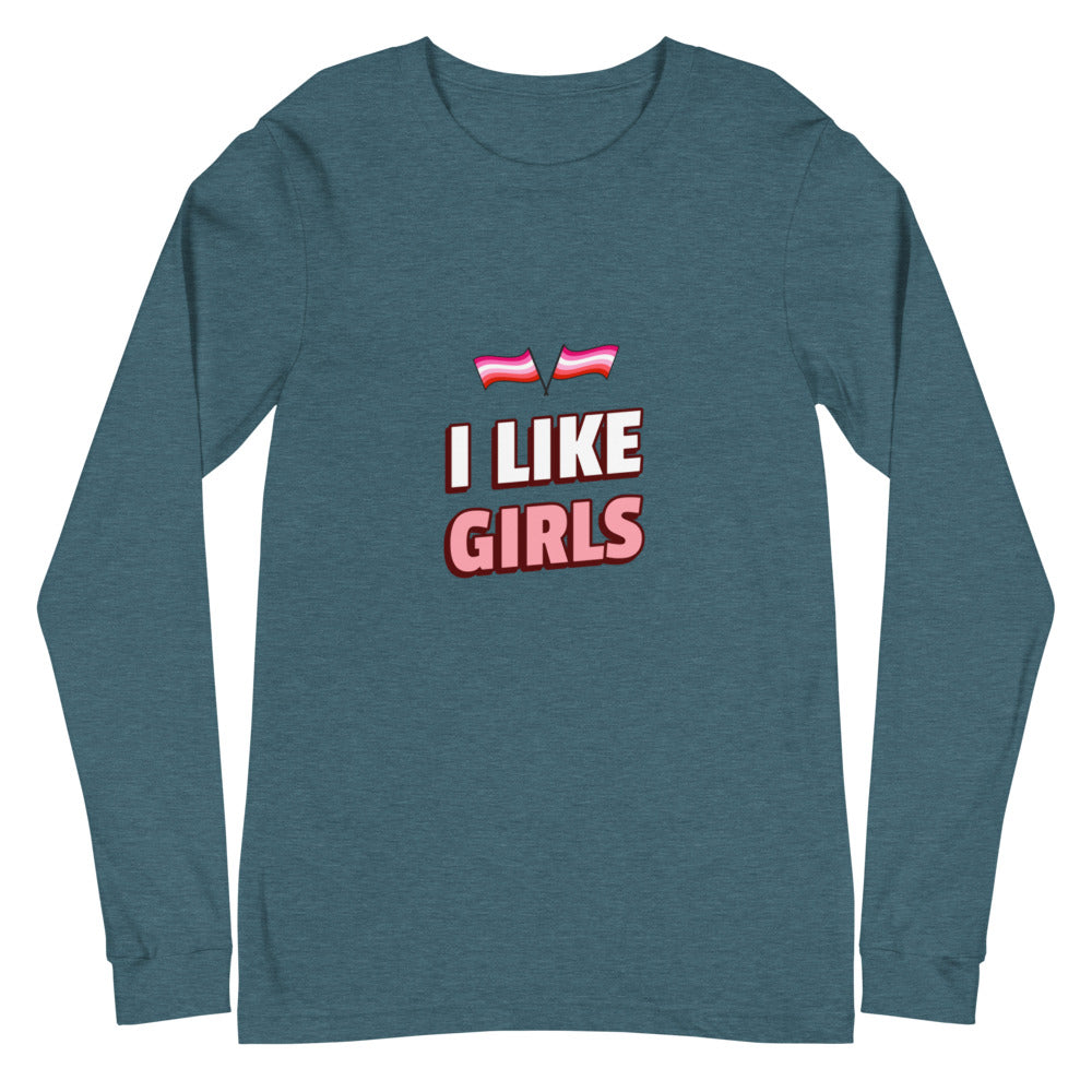 Unisex long sleeve tee reads “I Like Girls,” featuring lesbian pride flags. Queer model with bold makeup, earrings, and dark hair poses confidently.