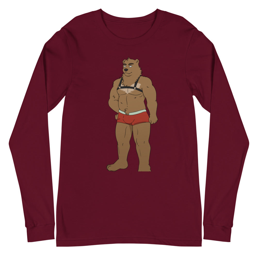 Burgundy Gay Bear Unisex Long Sleeve T-Shirt with a cartoon bear in a swimsuit harness, modeled by a femme queer, on gray background.