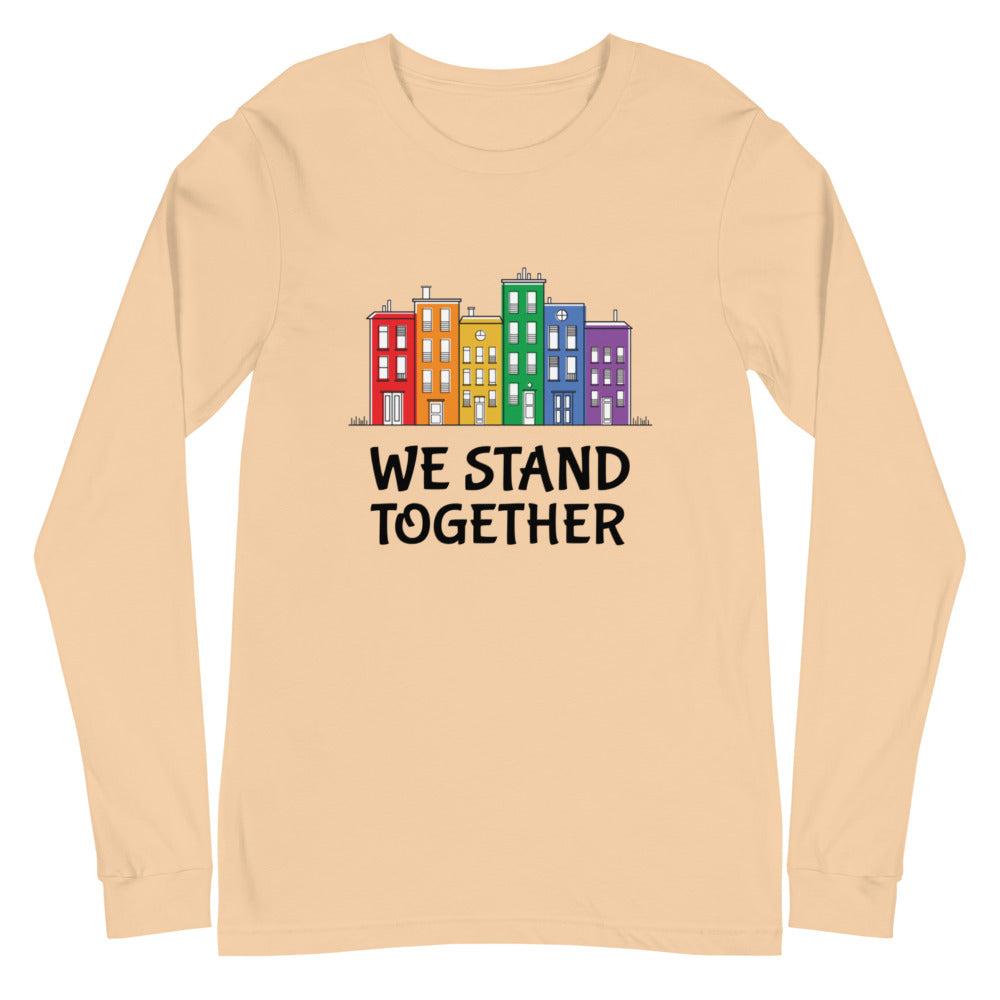Sand-colored long-sleeve shirt with colorful row houses and “WE STAND TOGETHER” text