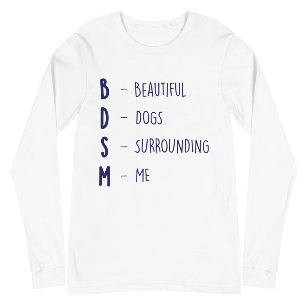 BDSM (Beautiful Dogs Surrounding Me) Unisex Long Sleeve T-Shirt, worn by a queer woman with short hair, pops against a brick wall.