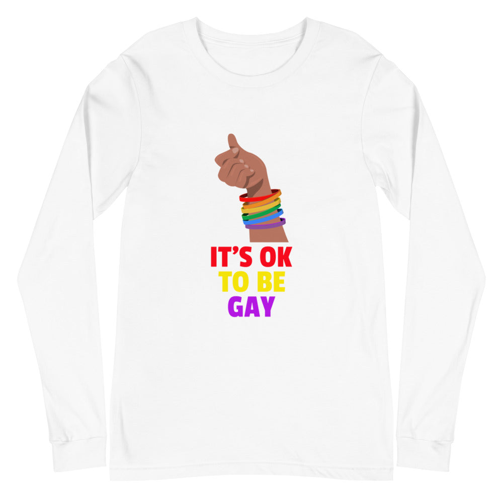 Front view of a white long-sleeve shirt reading “IT’S OK TO BE GAY” with a rainbow-cuffed fist