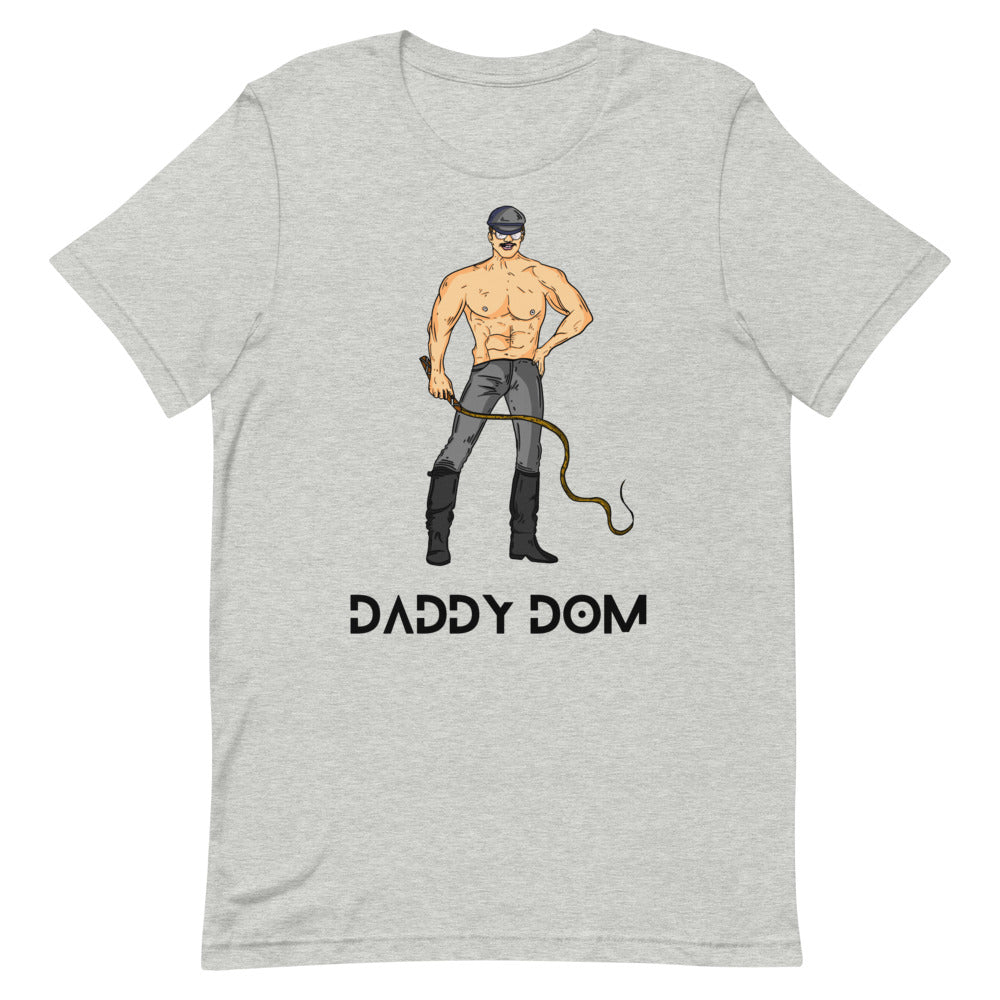 Flat-lay gray T-shirt with a leather-clad man, riding crop, and “DADDY DOM” text