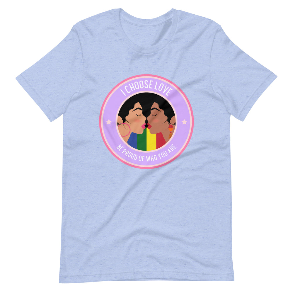 Flat-lay light blue T-shirt with two women kissing and a rainbow, reading “I CHOOSE LOVE” and “BE PROUD OF WHO YOU ARE.”