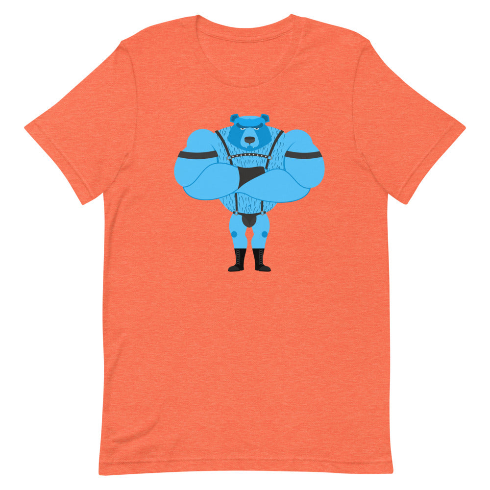 Fetish Gay Bear T-Shirt, orange with blue cartoon bear, worn by a man beside a woman in green. They smile, arms linked, amid rainbow flags.