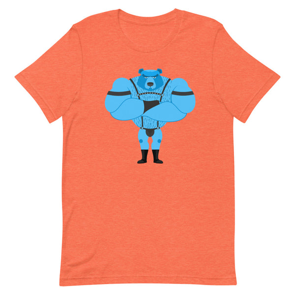 Fetish Gay Bear T-Shirt, orange with blue cartoon bear, worn by a man beside a woman in green. They smile, arms linked, amid rainbow flags.