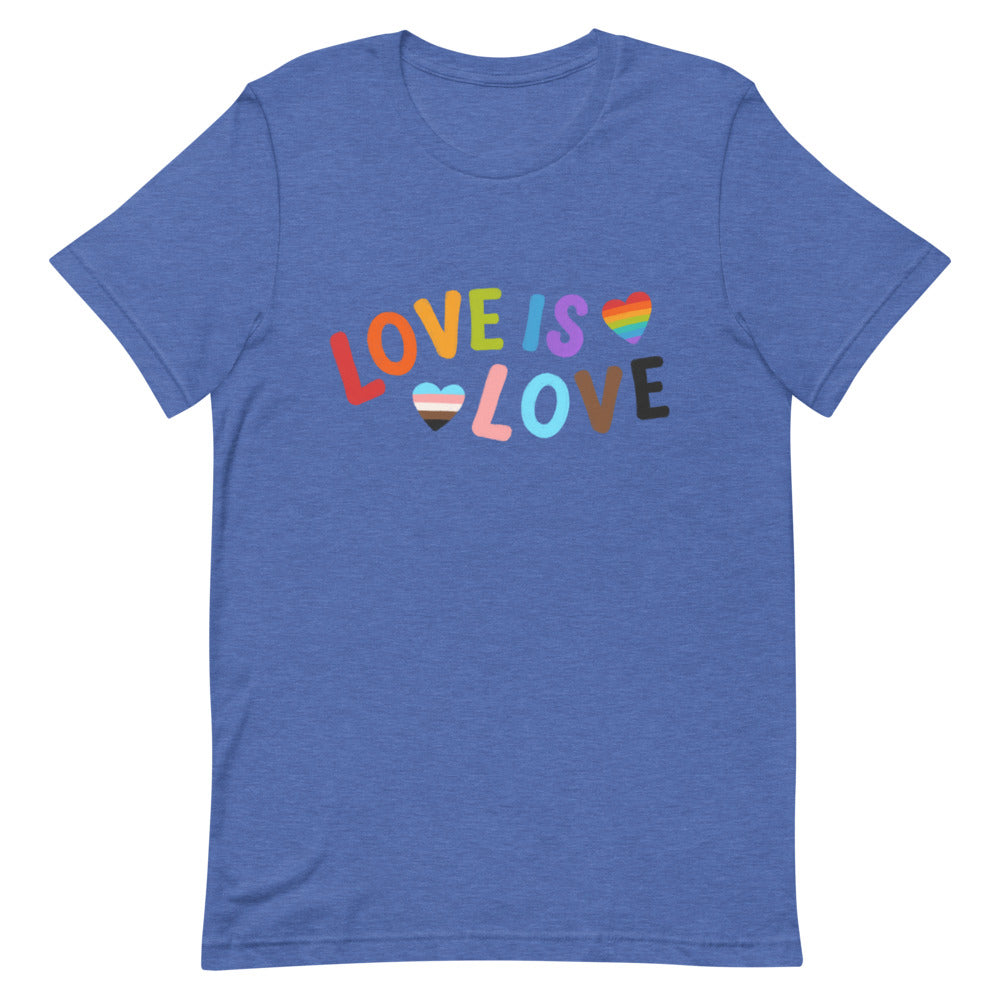 Flat-lay blue T-shirt with colorful “LOVE IS LOVE” lettering and two heart flags